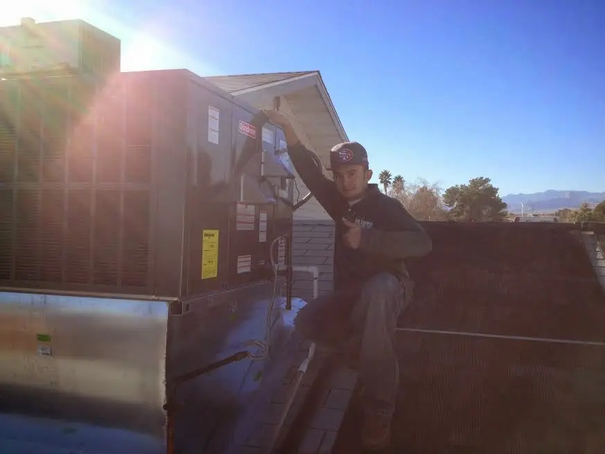 HVAC technician performing Air Duct Repair on a rooftop unit in Southampton
